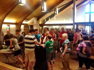 people at July service, washing away confessions in the font